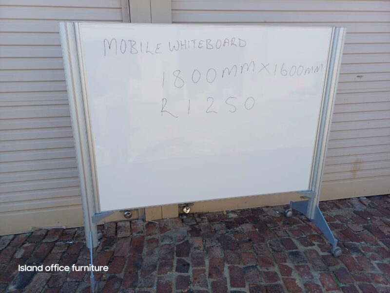 Mobile whiteboard with dimensions and price written, displayed outside on concrete surface.