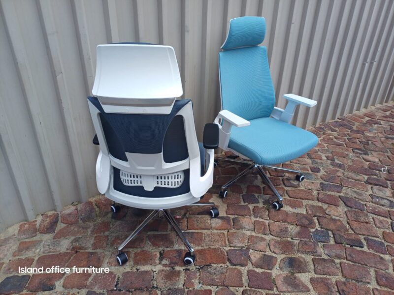 Moritz Ergonomic Grey Chair with headrest, 3D armrests, shown from the back and side on a brick surface.